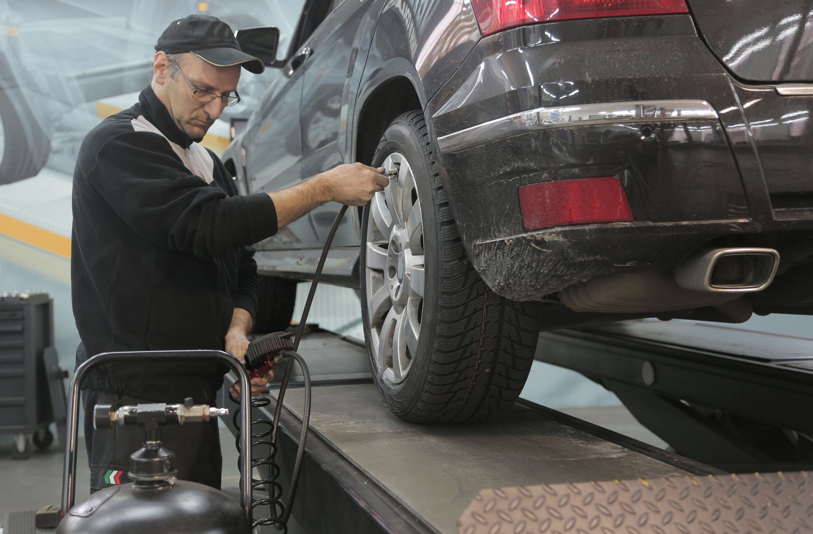 Technician servicing a car wheel