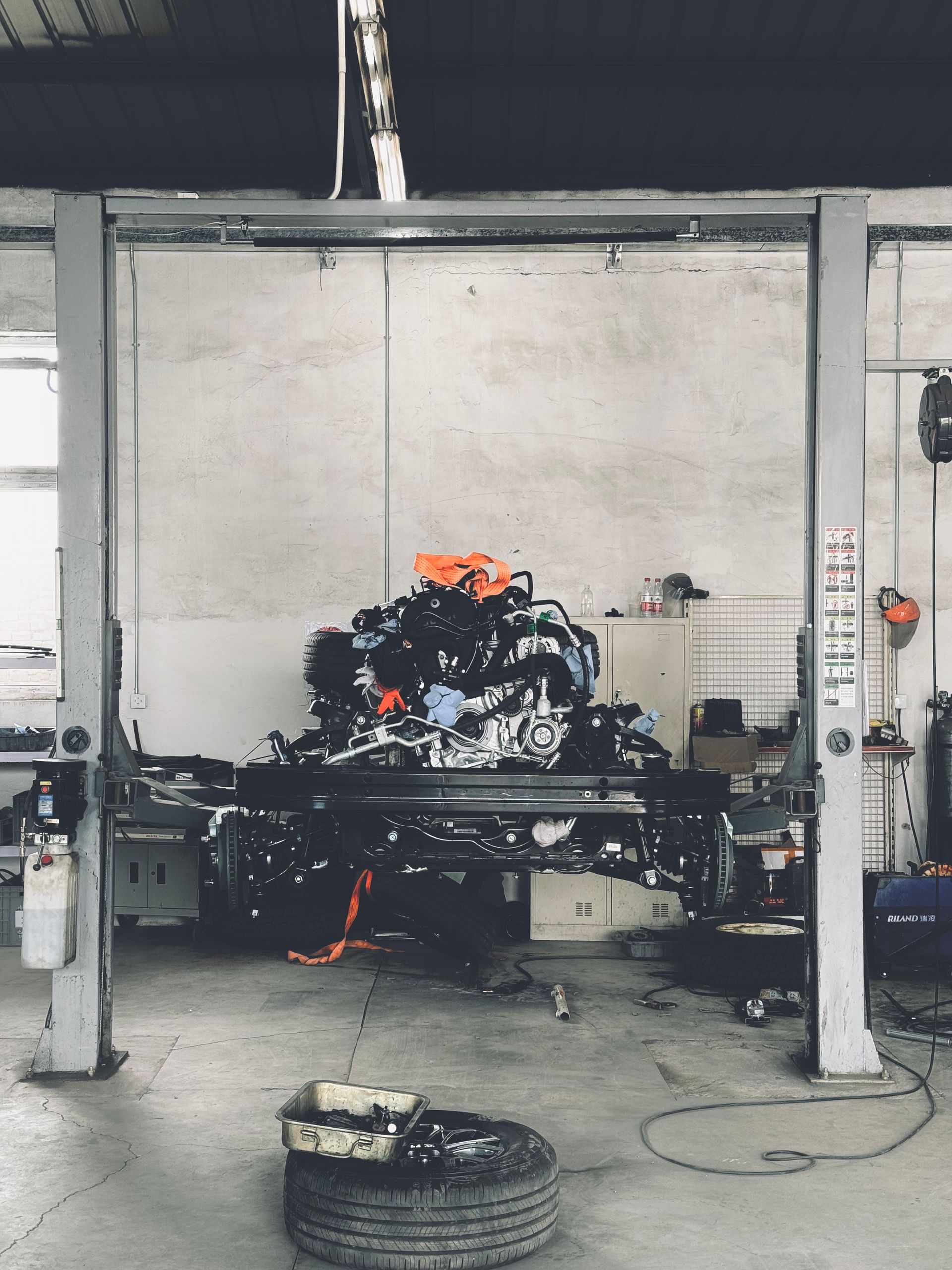Technician servicing a car at The Green Automobiles workshop